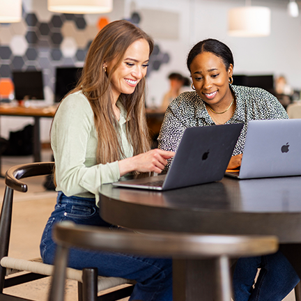 Life-at-Lunne-Charlotte-two-women-smiling-working-on-laptops